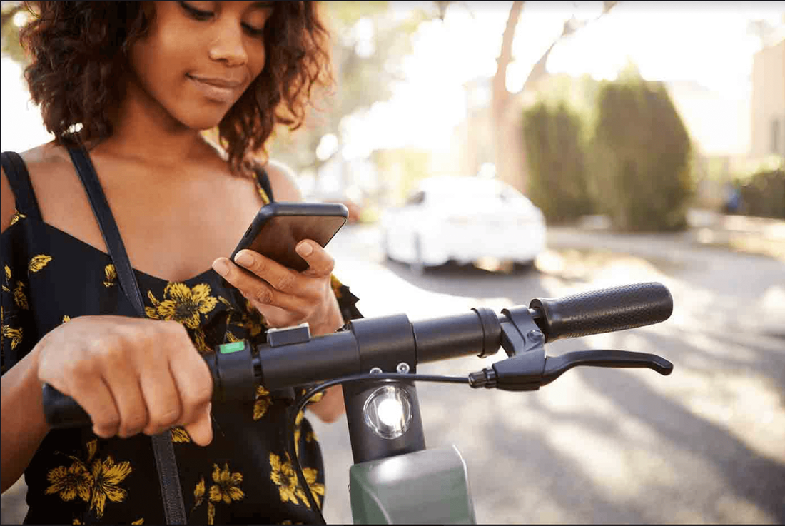 Girl unlocking Zoom scooter using the app