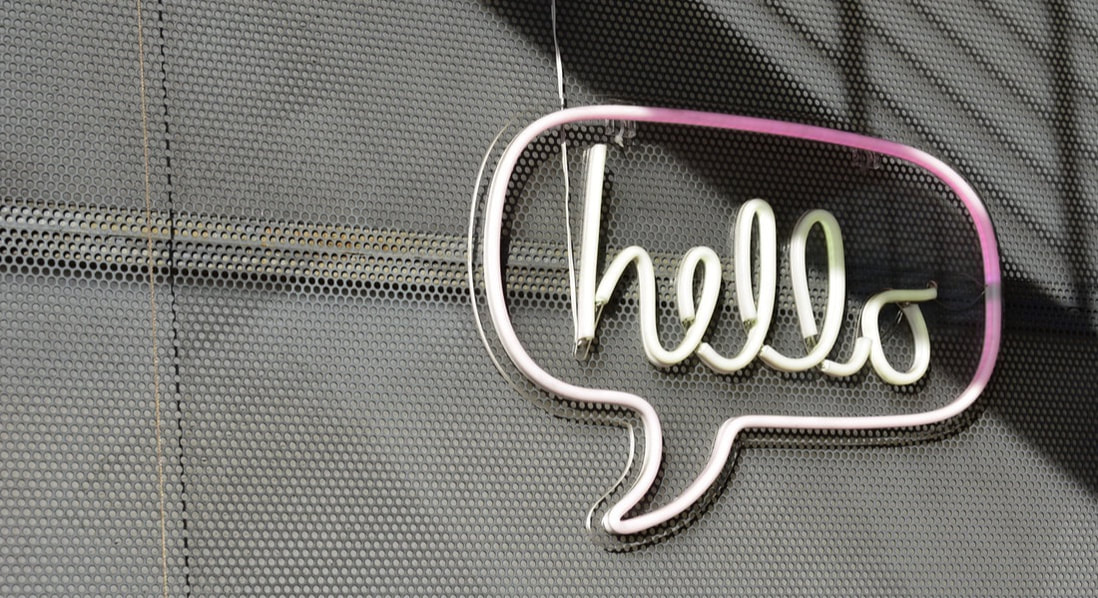 Neon with white letters saying hello